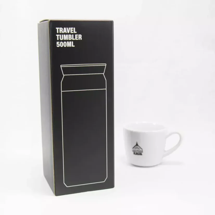 Original packaging of the Kino Travel Tumbler Khaki 500ml thermos and a white coffee cup in the background