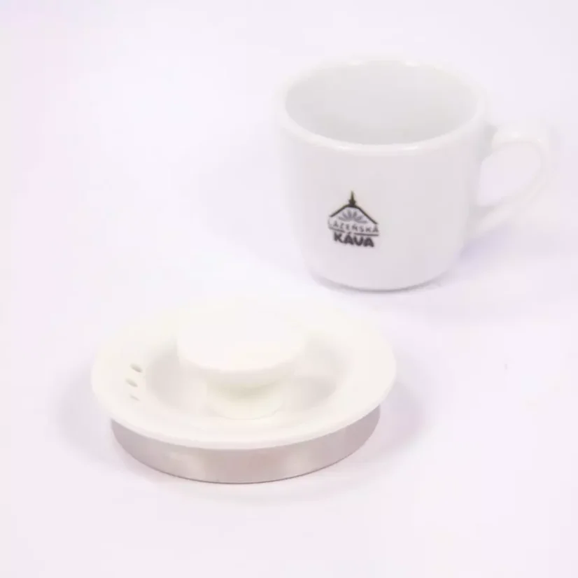 White electric kettle lid on a white background with a cup of spa coffee
