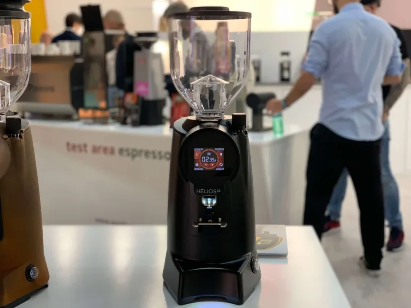 White Eureka Helios 65 espresso grinder, equipped with a timer for precise dosing of ground coffee.