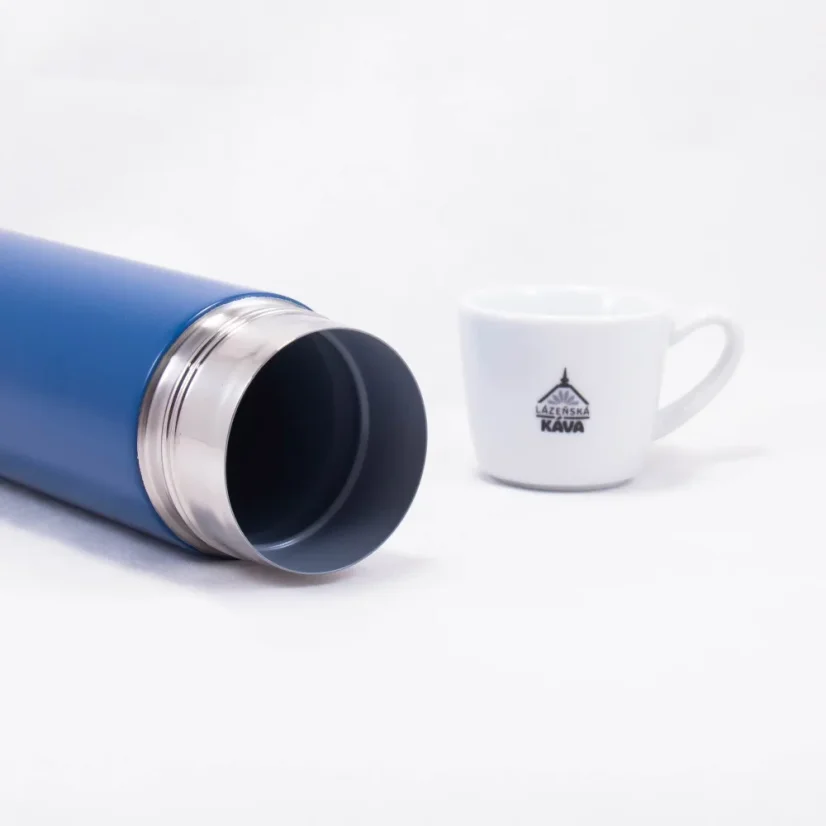 Detail of the thermos body with coffee in the background