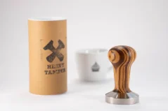 Zebrano Heavy Tamper 58 mm and a coffee cup Zebrano Heavy Tamper 58 mm and a coffee cup
