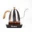 Silver electric kettle with a wooden handle on a black base with a goose neck on a white background, side view.