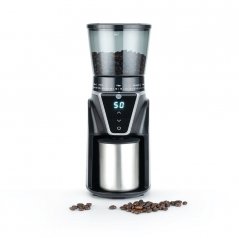 Silver electric grinder by Wilfa. In the foreground there are coffee beans.