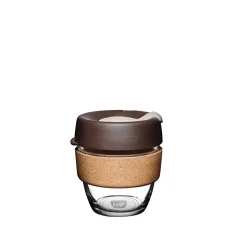 Glass thermal mug with brown lid and cork holder.