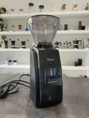 Black electric Baratza Encore coffee grinder with a black plastic hopper. Black electric Baratza Encore coffee grinder with a black plastic hopper.