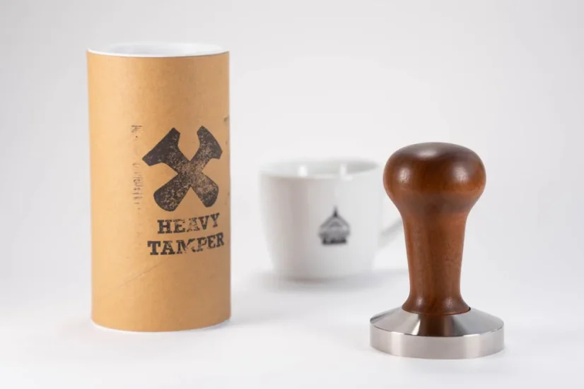 58.6 mm Heavy Tamper Classic Walnut and a cup of coffee