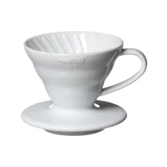 Hario V60-01 white ceramic dripper on a light background. Hario V60-01 white ceramic dripper on a light background.