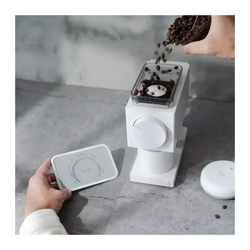 Whole bean coffee and the grind setting of the Fellow Ode grinder in white color