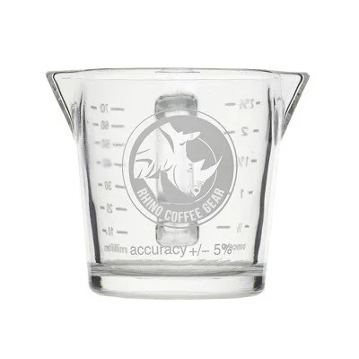 Double-spouted Rhinowares glass measuring cup for baristas, designed for double espresso.