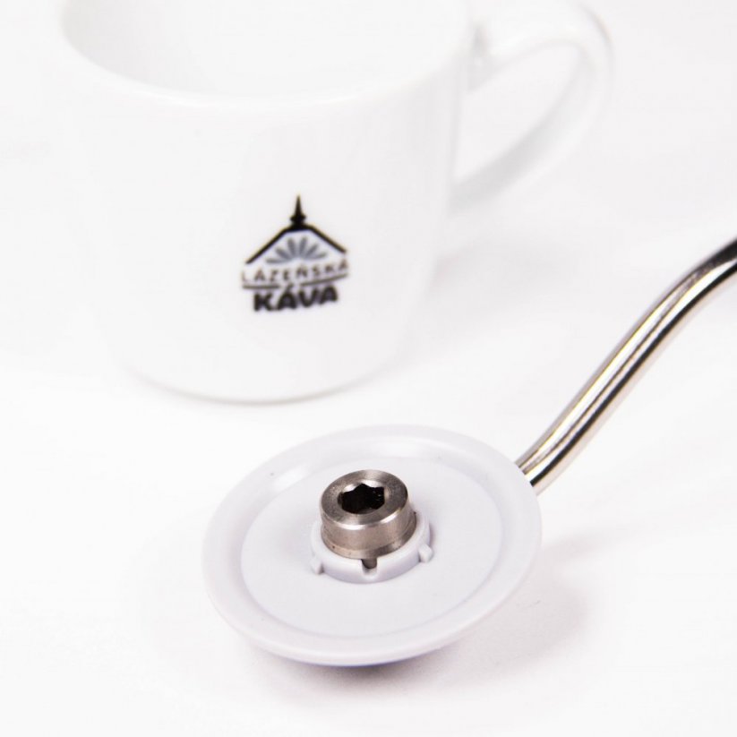 Timemore C2 manual coffee grinder in white with grey handle. In the background is a cup with the Spa Coffee logo.