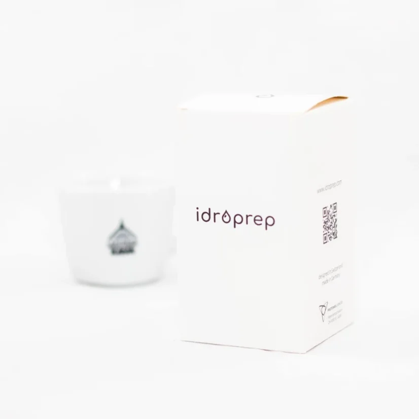 Bündel des Idroprep-Tamper mit Kaffee im Hintergrund.
