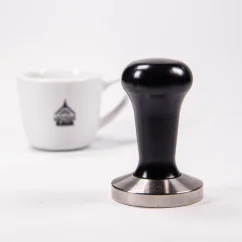 Tamper 58.4 mm with a black handle and a coffee cup. Tamper 58.4 mm with a black handle and a coffee cup.