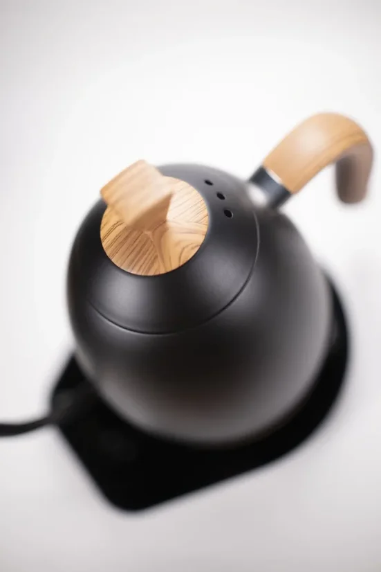 Close-up of a Brewista electric kettle lid in matte black with wooden elements