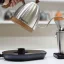 Electric kettle in luxurious silver finish with wooden accents.