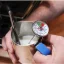 Close-up of milk temperature measurement with a thermometer by Rhinowares Close-up of milk temperature measurement with a thermometer by Rhinowares