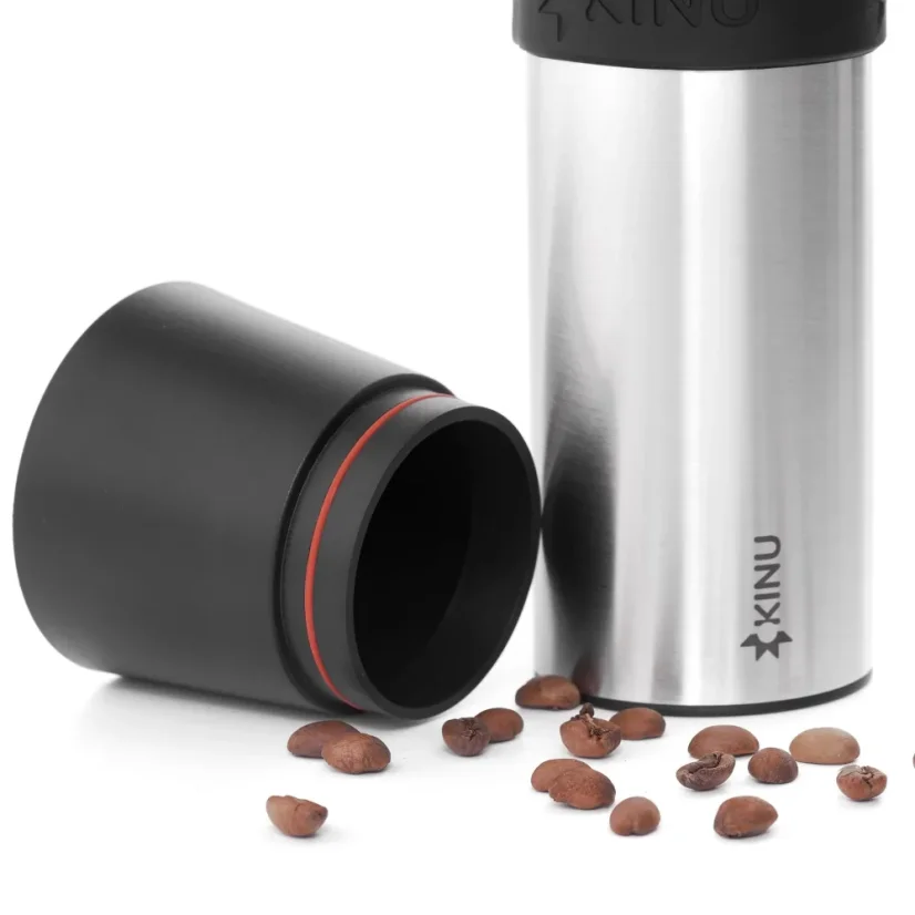 Detail of the black funnel of the Kinu M47 Phoenix manual grinder, complemented by coffee beans