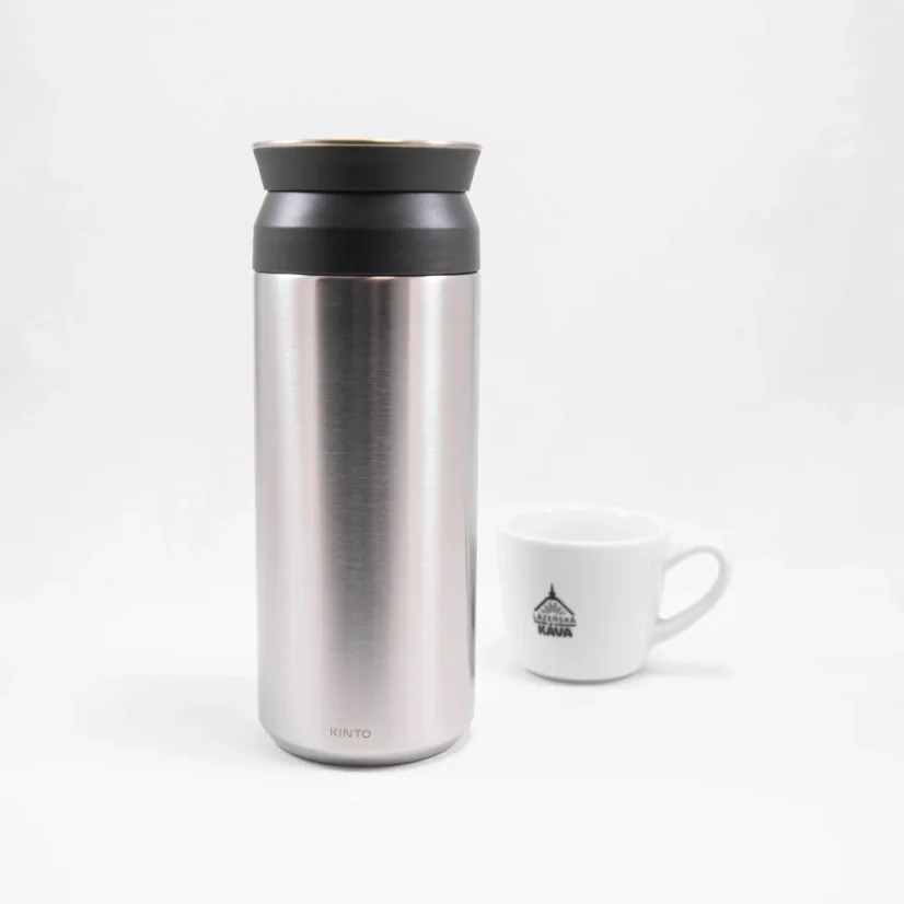 Graue Edelstahl-Thermoflasche Kinto auf weißem Hintergrund mit einer Tasse Kaffee.