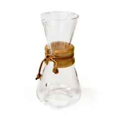 Glass Chemex with an extended head, wooden handle, and leather cord.