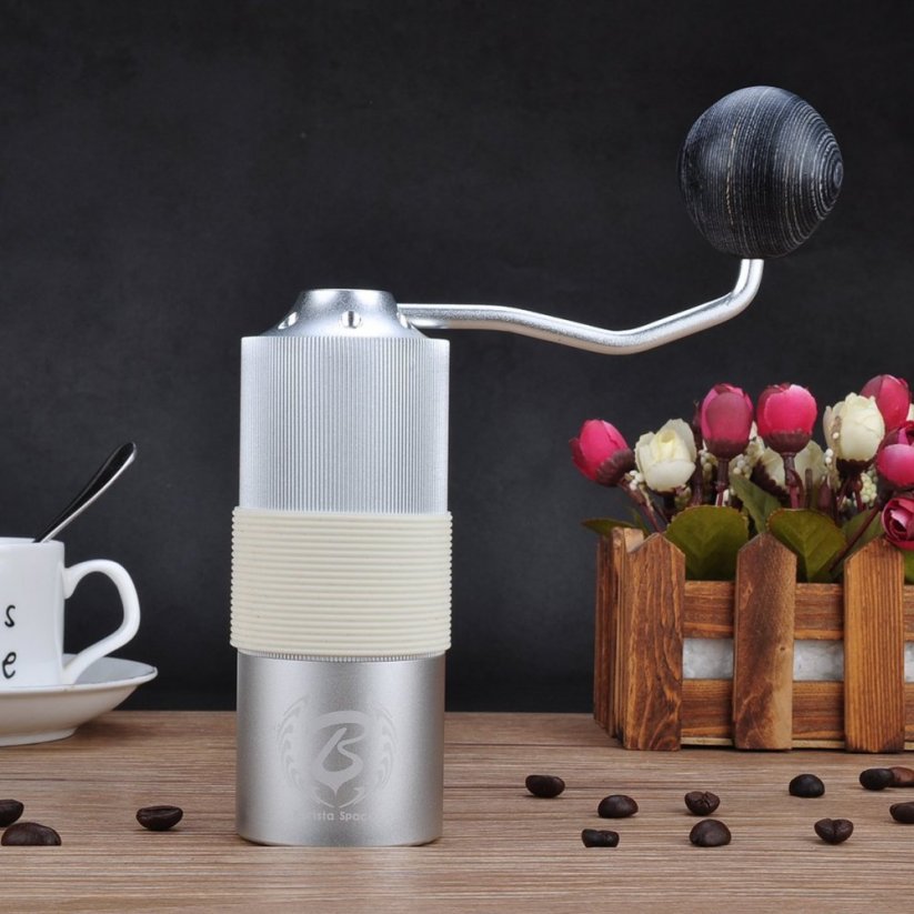 Barista Space Grinder placed on the table with coffee and cup
