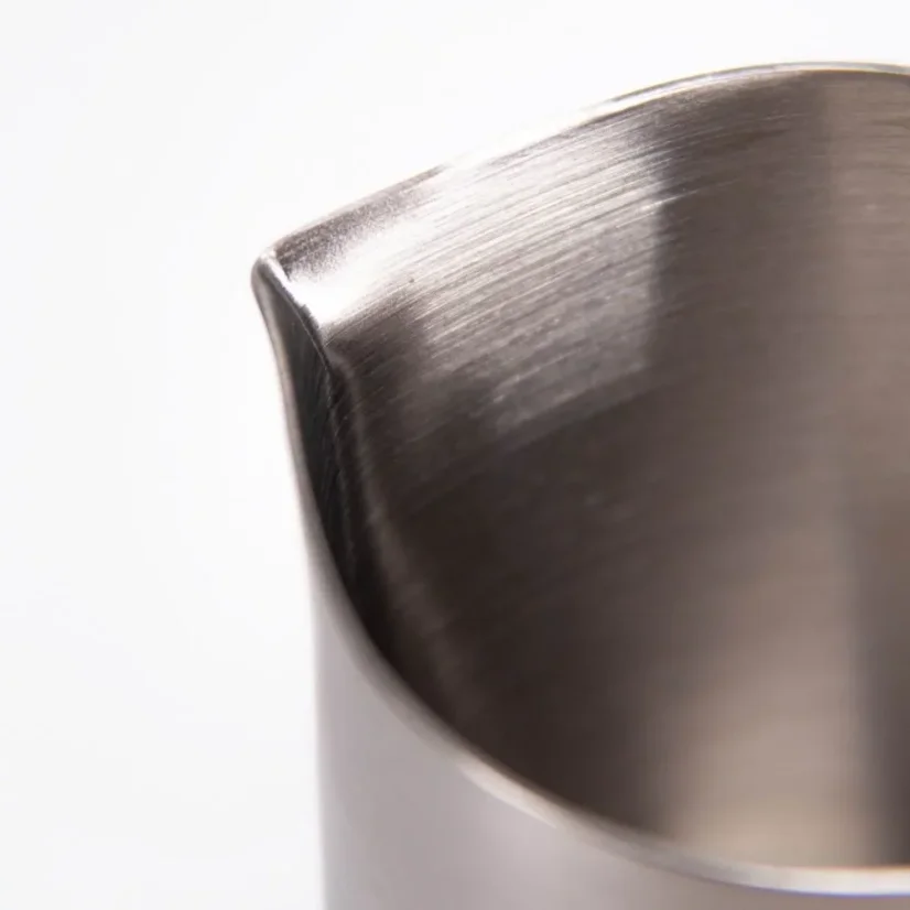 Silver Subminimal Flowtip milk jug on a white background, detail on the spout of the jug.