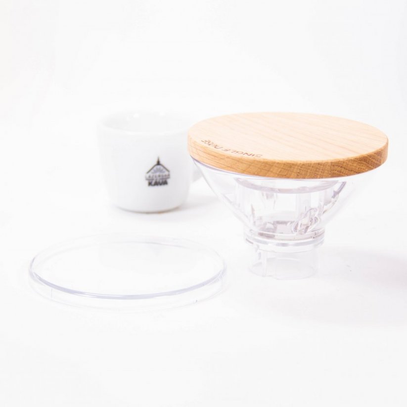 The hopper of the Eureka grinder, next to the cup with the logo of Spa Coffee.