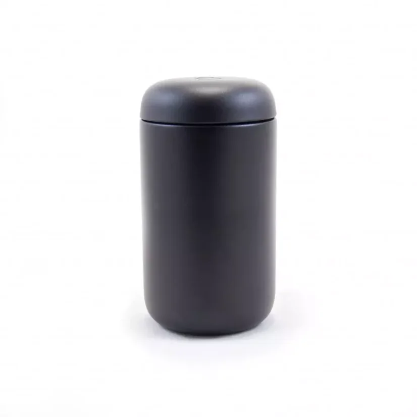 Thermal mug from the front with coffee in the background