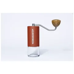 Hand-operated Comandante grinder in red color.