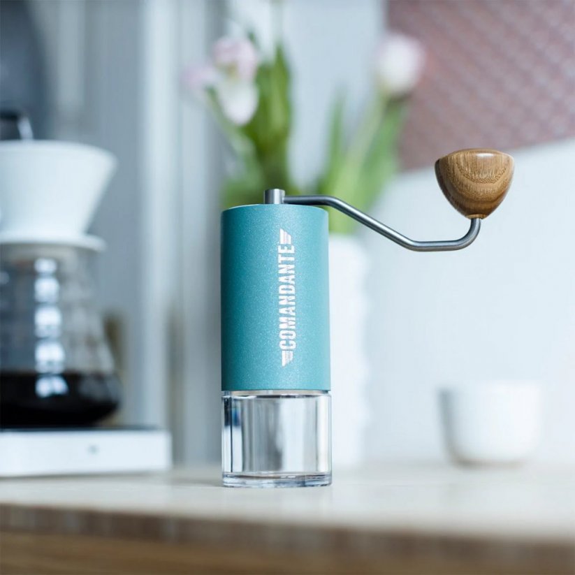 Hand grinder Comandante C40 MK4 in Alpine Lagoon colour, placed in the kitchen environment.