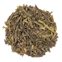 Loose green tea China Sencha on a white background, top view