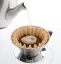 Pouring water over coffee in a paper filter and Kalita Wave 185 dripper.