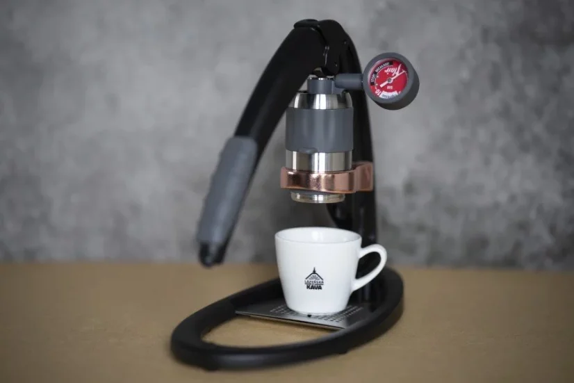 Black Espresso Maker Flair Pro 2 on a table with a cup of coffee