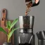 Pouring coffee into the hopper of the Wilfa Balance CG1B-275 grinder.