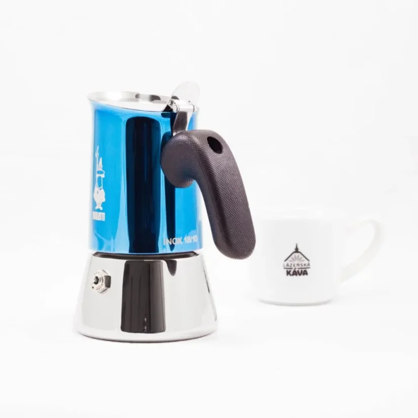Bialetti New Venus in blue for 2 cups of coffee with coffee in the background.