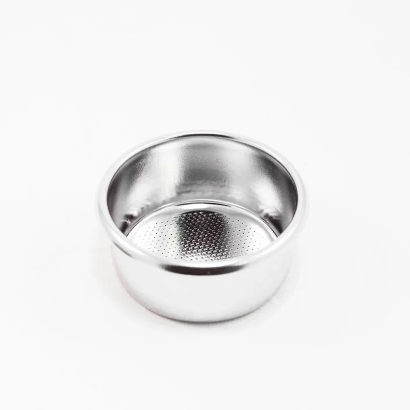 Silver portafilter basket on a white background, top view of the inner part of the basket.