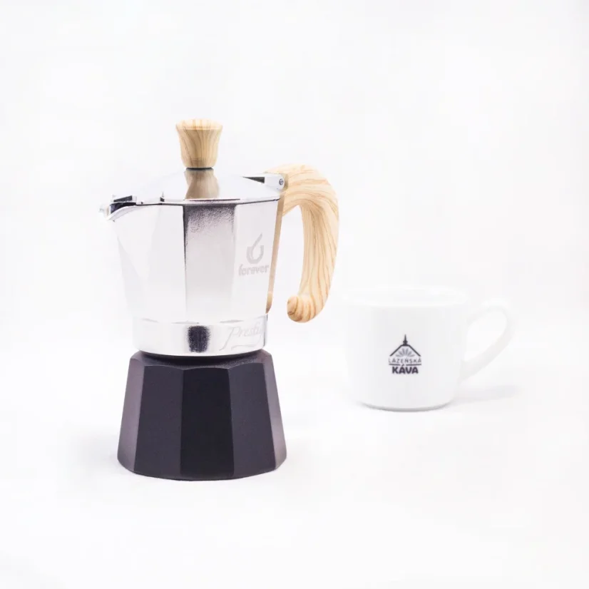 Moka pot with a wooden handle and black water spout for two servings of coffee, Forever Miss Moka Woody with a white cup in the background
