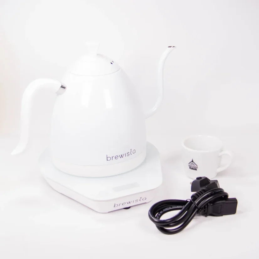Electric kettle by Brewista in elegant white goose-neck design next to a cup with coffee logo and power cable.