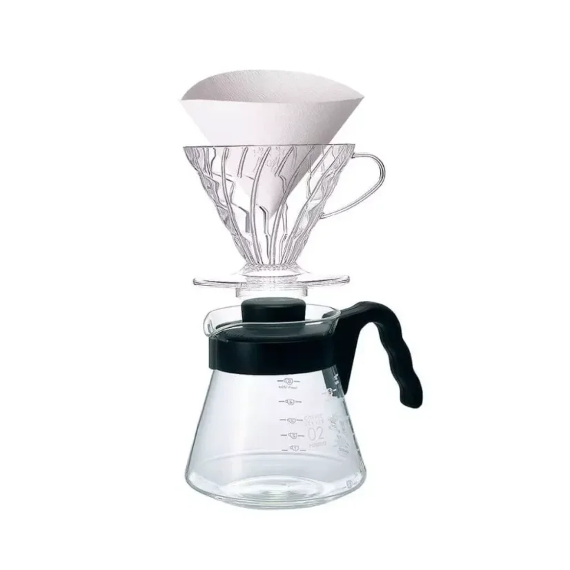 Plastic dripper with a paper filter and glass container with a black handle.