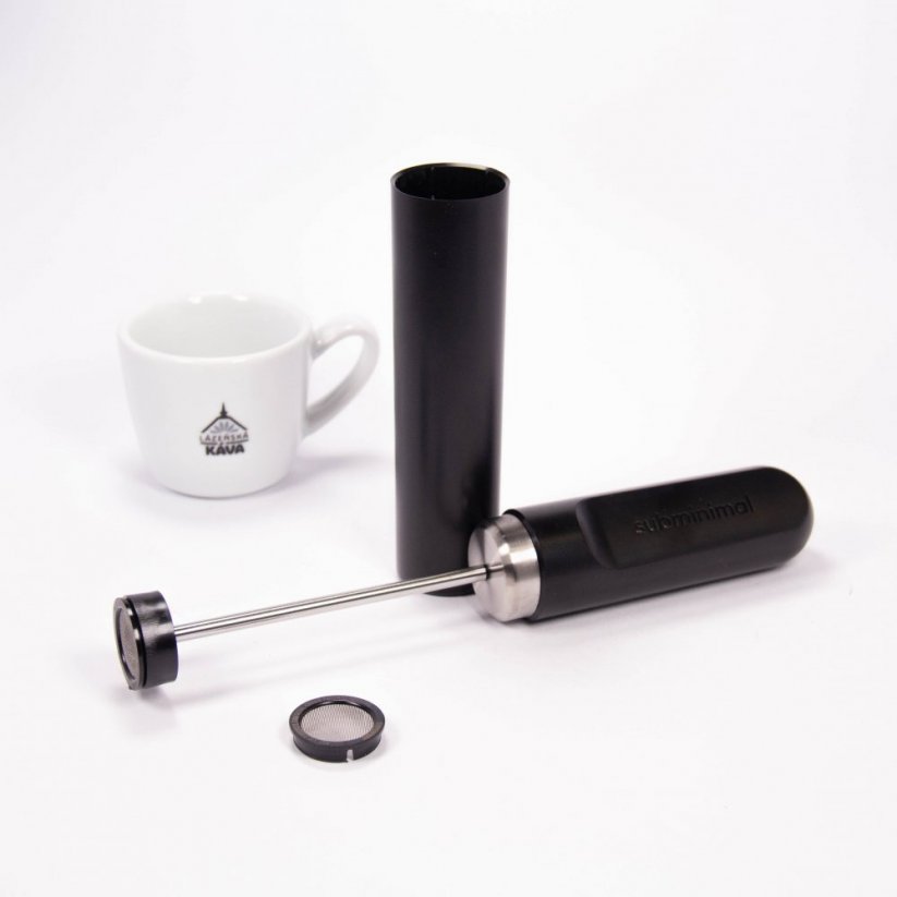 An unpacked Subminimal frother next to a cup with the Spa Coffee logo.