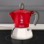 Moka kettle in red colour built on induction plate.