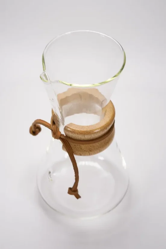 Glass Chemex with a wooden handle featuring a leather string, top view