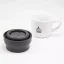 View of the inside of the lid of the Kino Travel Tumbler Khaki 500ml thermos, with a porcelain cup in the background.