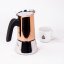 Bialetti teapot in Copper colour and a cup for prepared coffee.