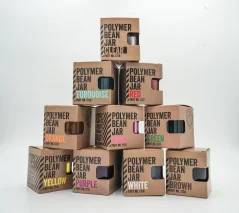Set of colorful coffee pods in original boxes stacked on top of each other in a pyramid on a white background