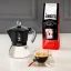 Coffee served in a clear cup, prepared in a Bialetti New Moka pot. Coffee served in a clear cup, prepared in a Bialetti New Moka pot.