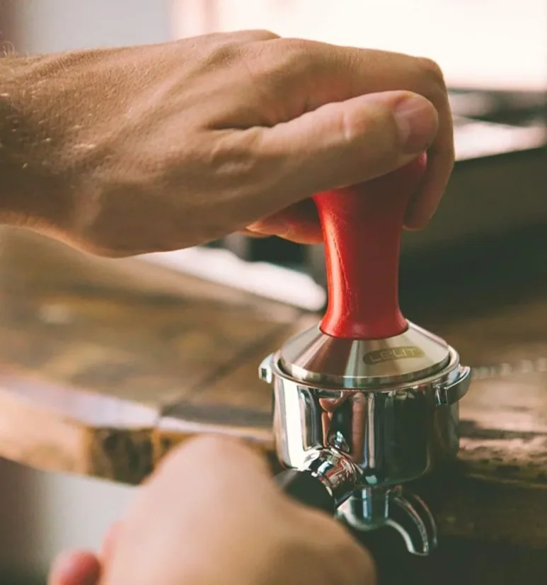Lelit tamper placed on coffee and portafilter.