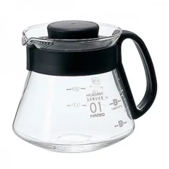 Glass Hario server with a black handle for coffee preparation.