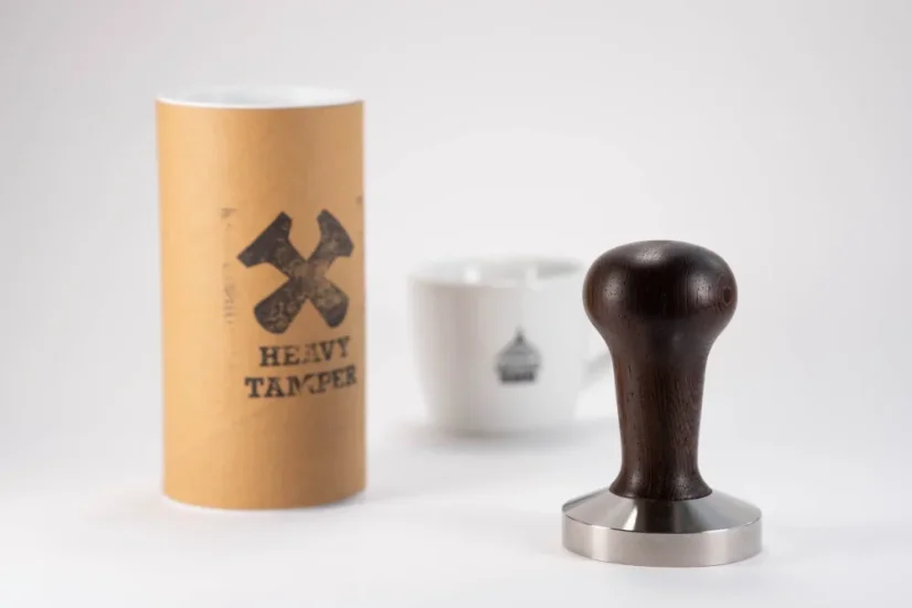 Heavy Tamper base 58.6 mm and a cup of coffee
