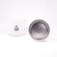 Filtro argentato per caffettiera Moka Bialetti appoggiato su un bordo su sfondo bianco con una tazza di caffè. Filtro argentato per caffettiera Moka Bialetti appoggiato su un bordo su sfondo bianco con una tazza di caffè.