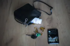 Handbag with Cannapio CBD capsules, keys, and a mobile phone.