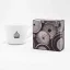 IMS basket for the portafilter in original packaging on a white background with a cup of coffee.